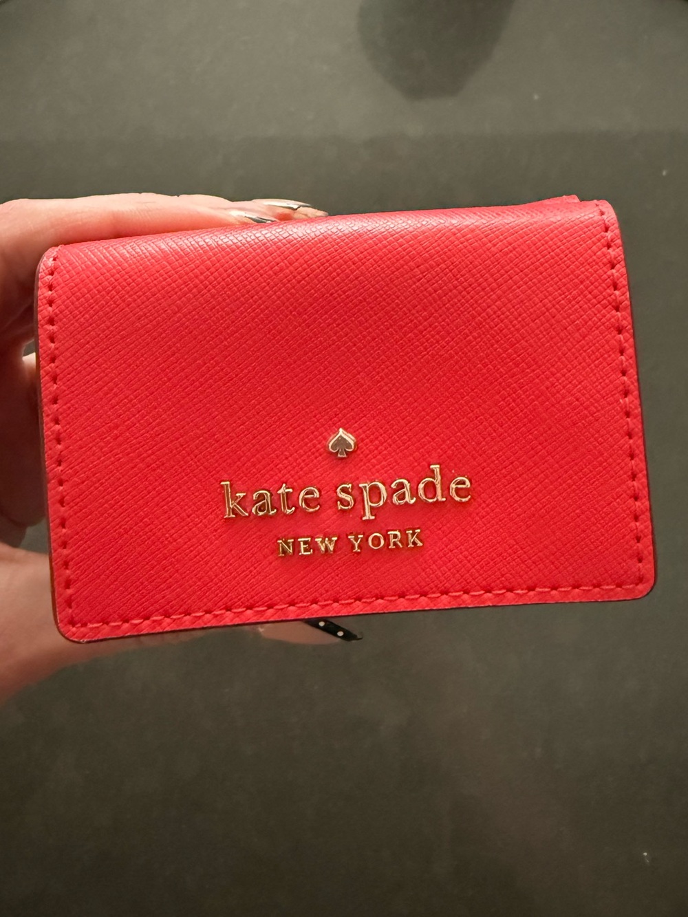 kate spade New York red compact card holder with gold logo